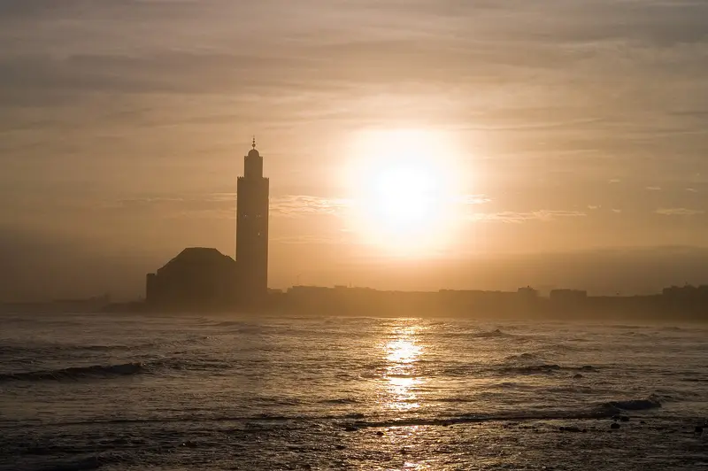 The Hassan II Mosque silhouetted at sunset over the Atlantic in Casablanca