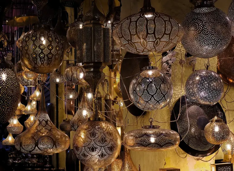 Handcrafted metal lanterns hanging in a souk of the Marrakech medina